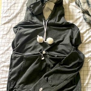 cat holding sweatshirt